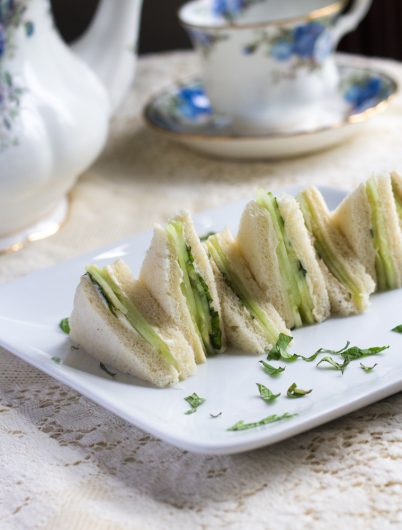 cucumber and mint sandwich with tea pot in background